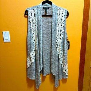 Nice Gray sleaveless cardigan with some designs in white